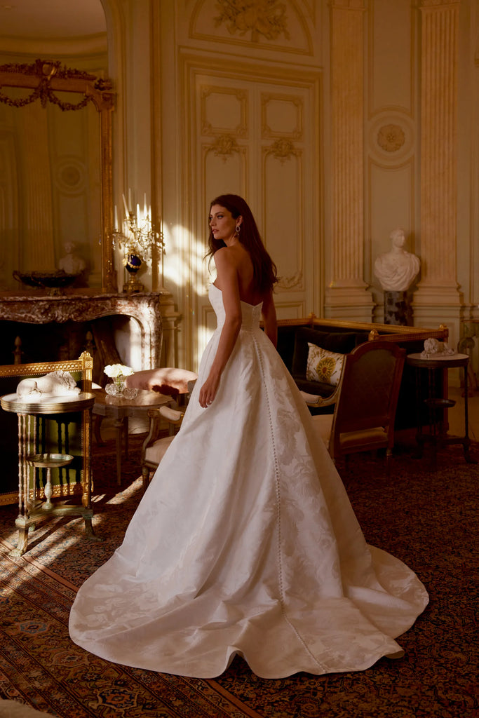 Bride wearing Justin Alexander josette ivory wedding dress back sold by le reve boutique