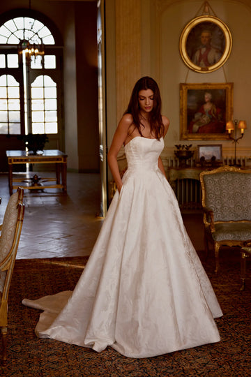 Bride wearing Justin Alexander josette ivory wedding dress front sold by le reve boutique