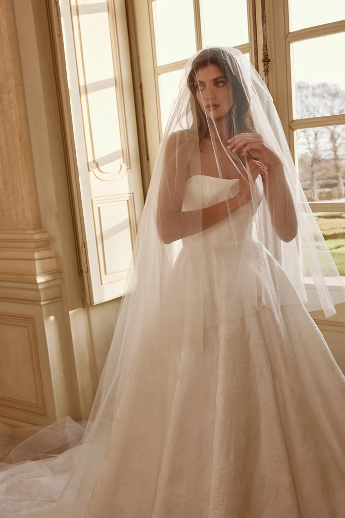 Bride with veil wearing Justin Alexander josette ivory wedding dress front close up sold by le reve boutique