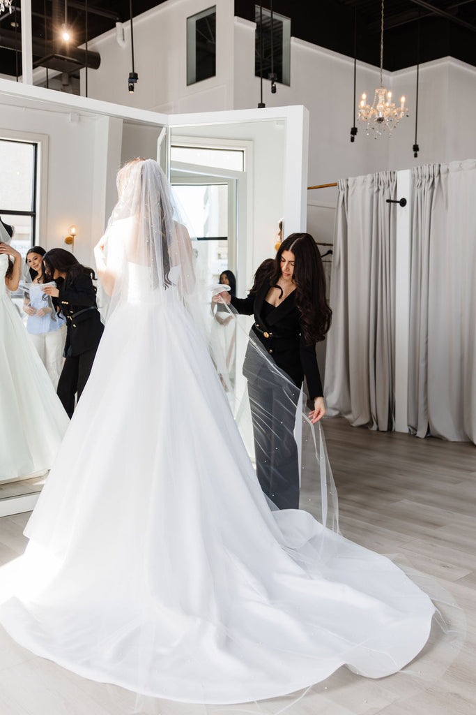 bride looking at herself at La reve boutique in Edmonton, Alberta