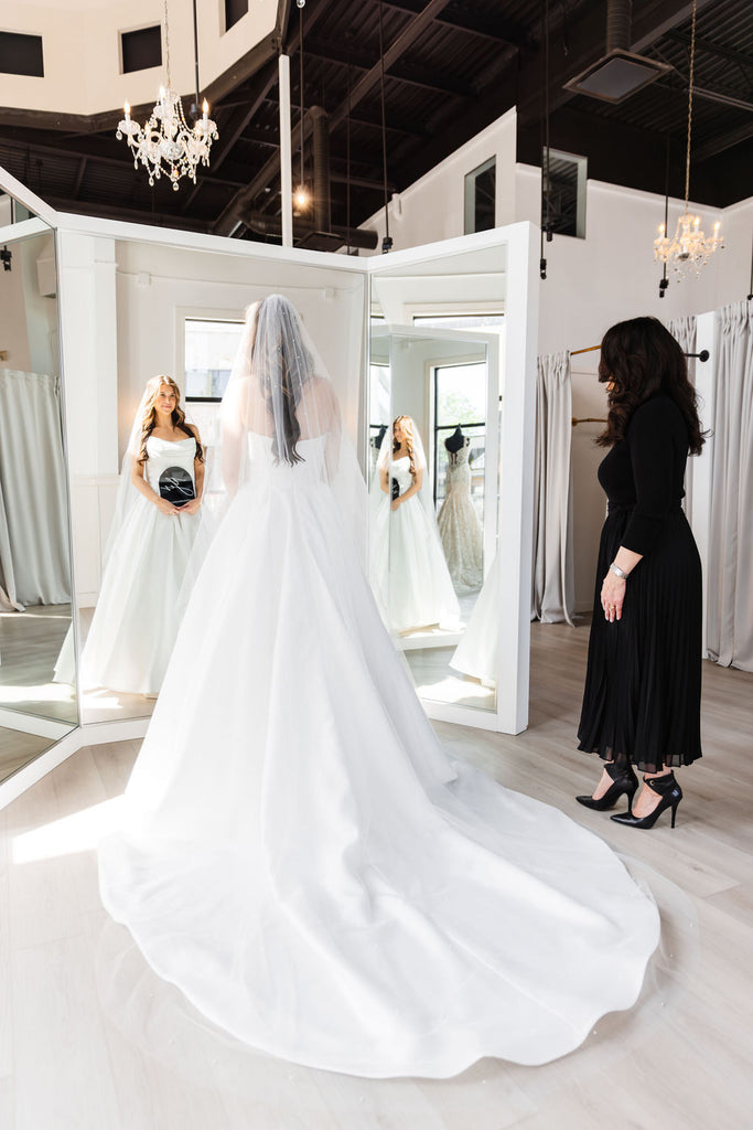 bride in a-line wedding dress saying yes to the dress with bridal consultant